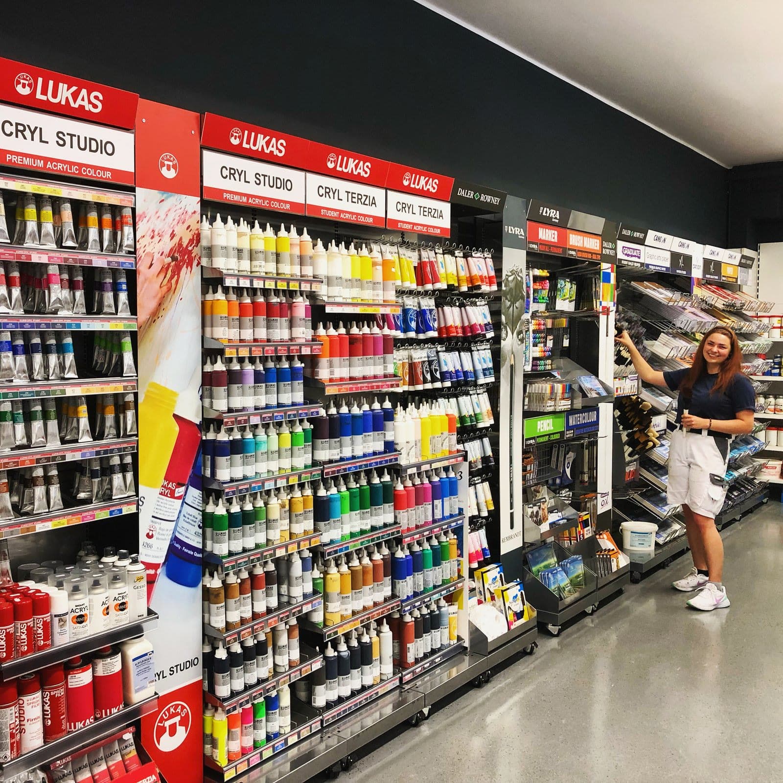 Beratung im Farbenfachhandel vor den Regalen